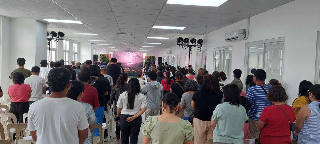Attendees standing in a hall during the Pililla Business Conference 2025, listening to speakers discuss topics related to labor laws, tax compliance, and corporate governance.