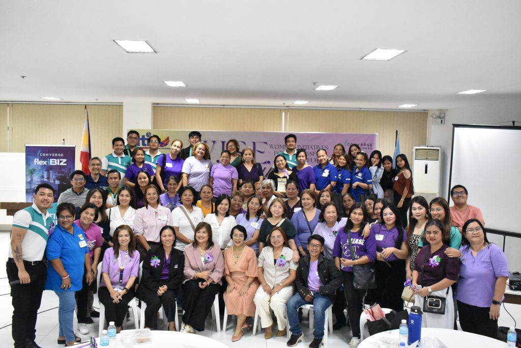 A large group of women and a few men pose for a photo at the Women's Initiatives for Successful Entrepreneurs (WISE) forum in Antipolo City, Rizal, celebrating women across all sectors in collaboration with DTI Rizal and Converge ICT.