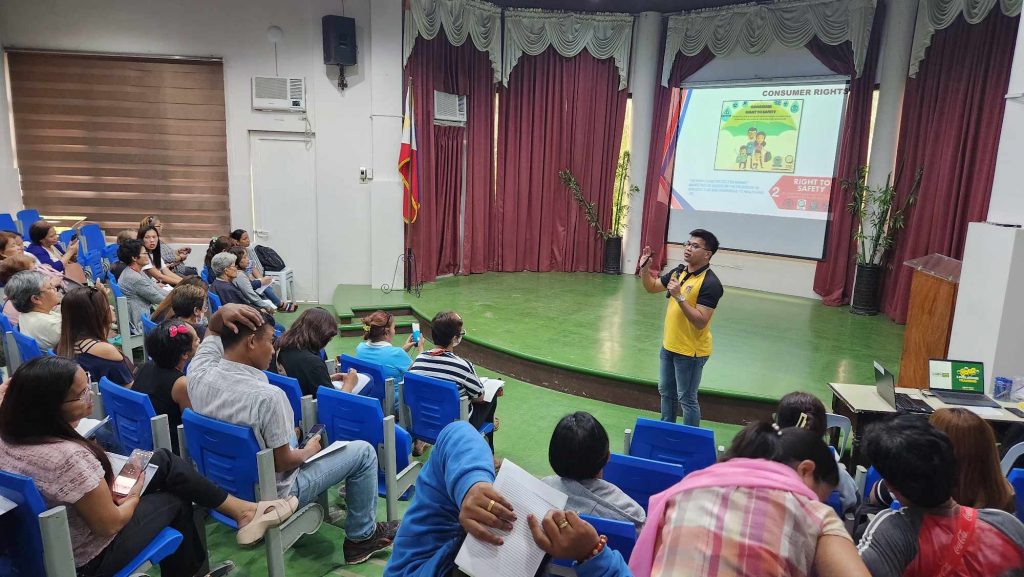 DTI-Laguna representative presenting business registration guidelines to micro-entrepreneurs during the seminar.