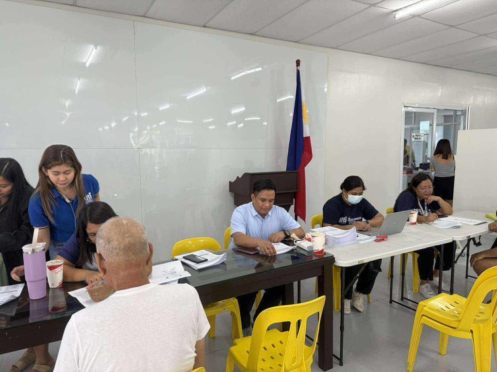 DTI-Laguna personnel conducting profiling and validation interviews with fire-affected vendors at the Santa Cruz Municipal Auditorium under the Pangkabuhayan sa Pagbangon at Ginhawa (PPG) Program.