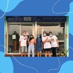 Joel and his wife Sarah and their children in front of their water refilling station.