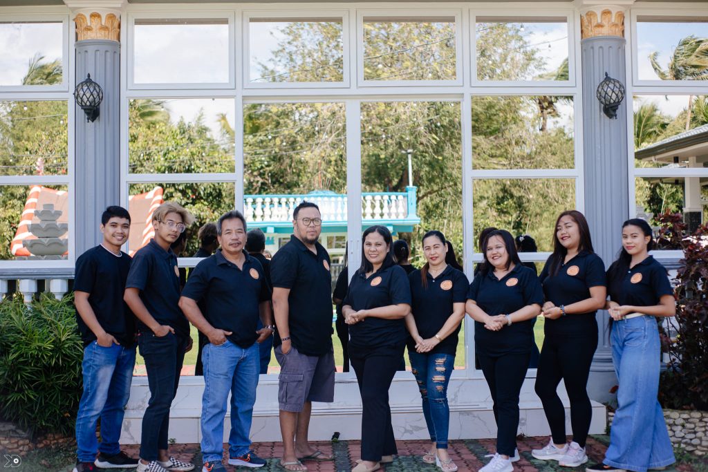 in photo: Haydee Cetro, the passionate owner of Empanada Ahuy, together with her staff.