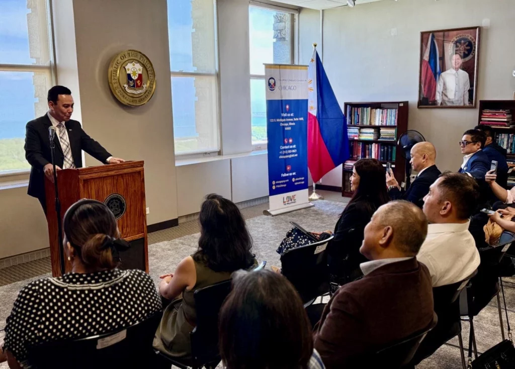 Trade Commissioner Benedict M. Uy presenting the evolution of the Philippine IT-BPO industry during a seminar at the Philippine Consulate in Chicago, with a screen showing key industry milestones and participants listening attentively.