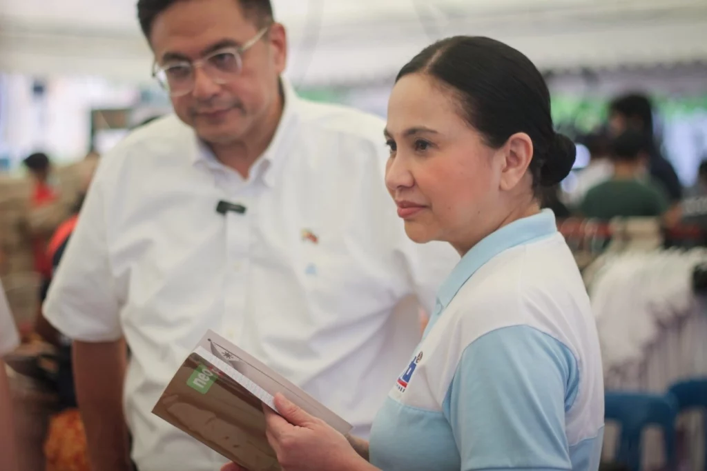 DTI Secretary Cristina A. Roque visits a booth at the "Diskwento Caravan: Balik-Eskwela Edition" in Muntinlupa City, showcasing discounted school supplies and food items offered by MSMEs ahead of the new school year.