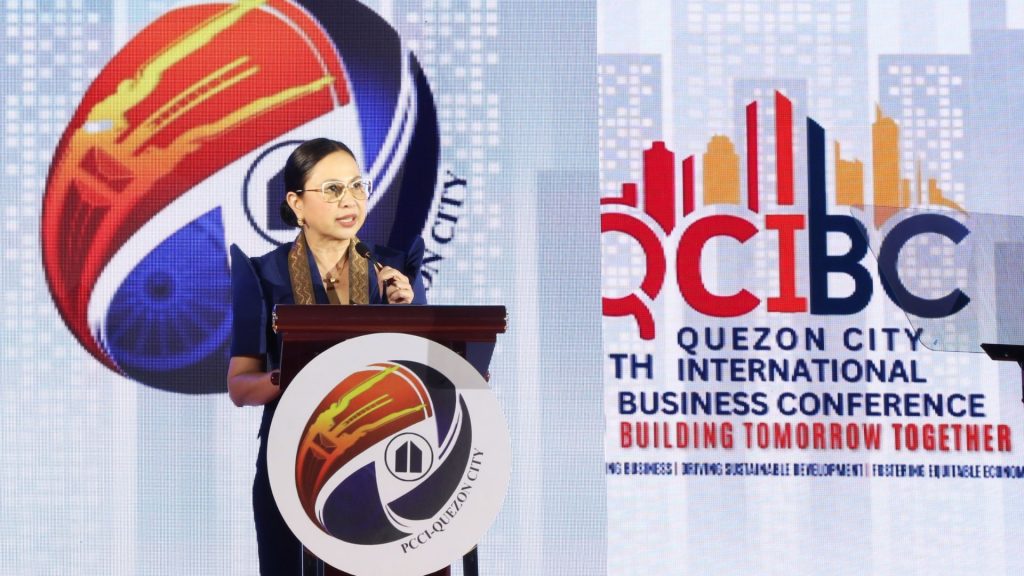 DTI Secretary Cristina A. Roque delivering a keynote address at the 5th Quezon City International Business Conference (QCIBC).