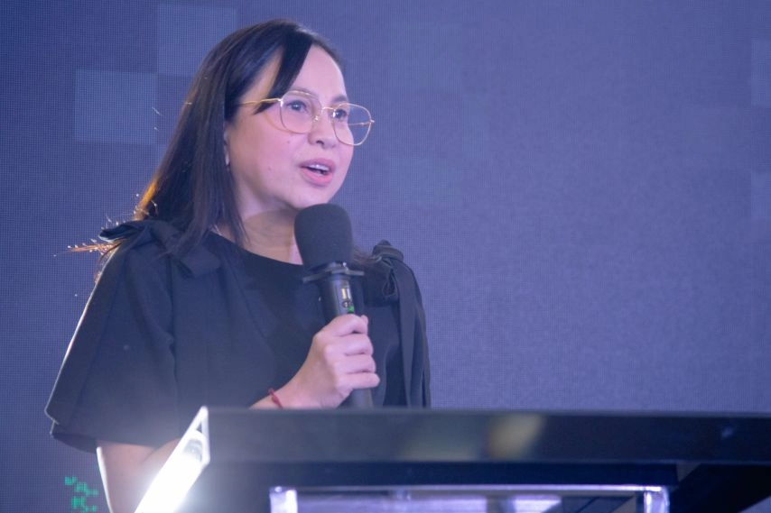 Trade and Industry Secretary Cristina A. Roque speaks at a podium during the launch of the FASHIONPhilippines Milan mentorship program, highlighting the Philippines’ push to showcase local design talent at Milan Fashion Week Spring/Summer 2026.