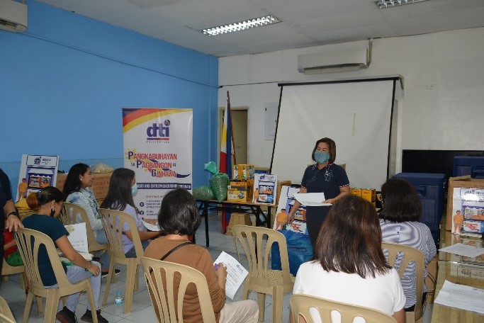Trade and Industry Development Specialist Jonalyn A. Adaya; facilitating the event and explaining the provisions written in the Pledge of Commitment