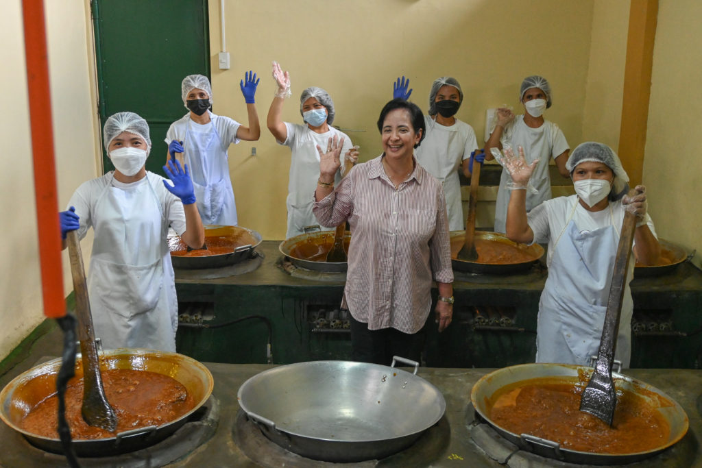 Inside the coconut jam factory where coconuts meat and syrup are harvested, Maureen inspects the site and her employees.