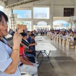 Regional Director Edna Dizon speaking at an event