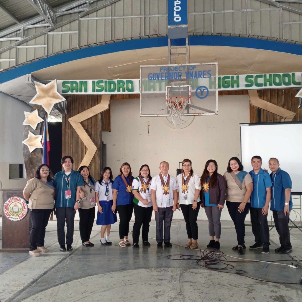 Representatives from DTI, DOLE, PESO, TESDA, and CHED, posing with some students and faculty at the San Isidro National High School's Career Guidance Week