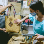 Catriona Gray holding a water hyacinth artwork