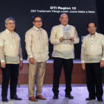DTI 12 Regional Director Jude Constantine S. Jaugan receives the plaque of recognition during the Juana Make a Mark Program Awarding Ceremony.