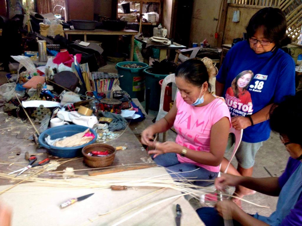 Three women working on a product