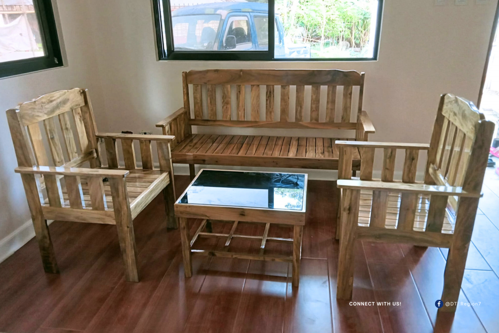 A handcrafted wooden sala set by Suyman Furniture displayed in a bright, homey interior—showcasing the quality and craftsmanship that turned a backyard dream into a thriving family business in Bohol, supported by DTI Region 7.