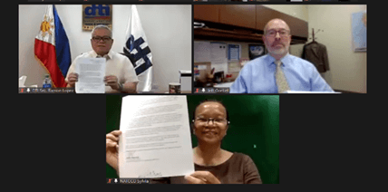 (From L-R) DTI Secretary Ramon M. Lopez, USAID OECD Chief Jeffrey Goebel, and NATCCO CEO Sylvia Paraguya holds their signed key messages in the ceremonial turnover of the Operations Manual 
