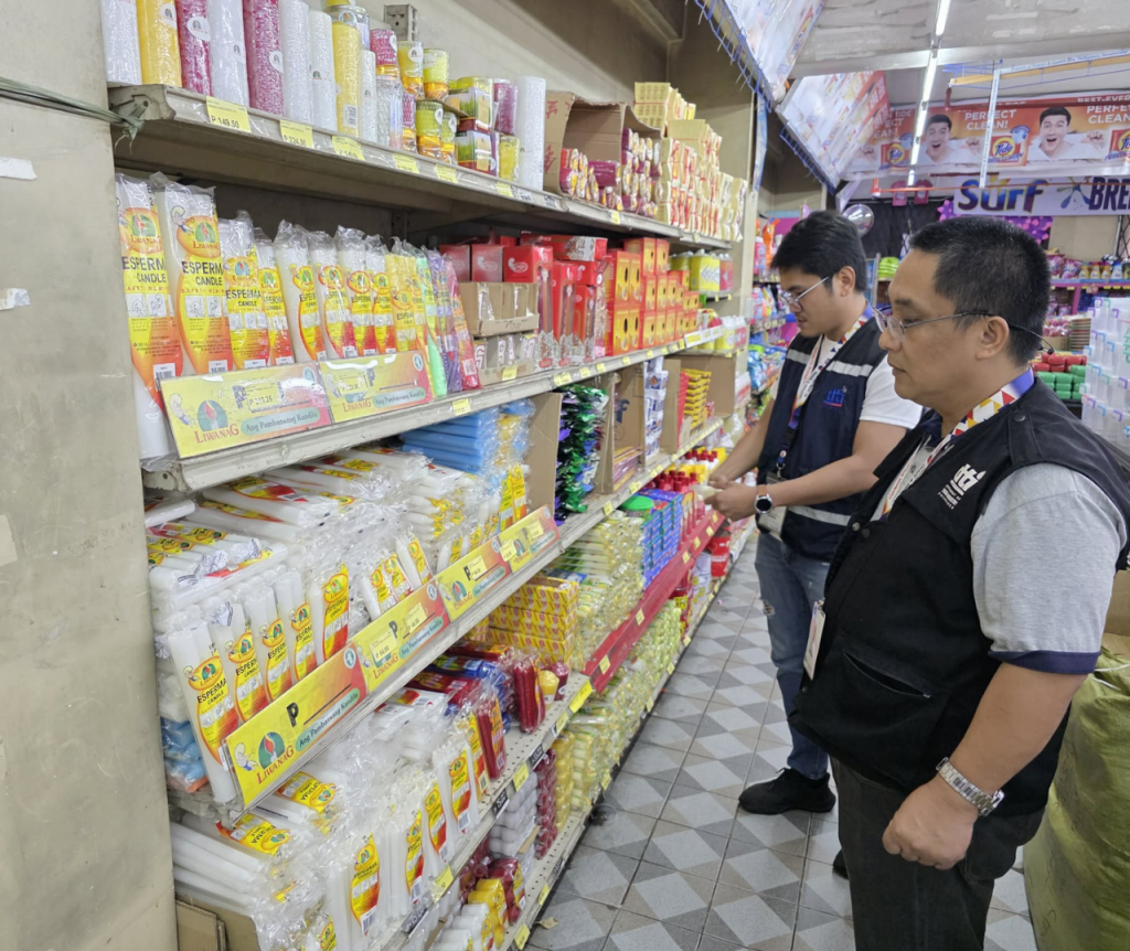 DTI personnel conduct price monitoring in a well-stocked store aisle to ensure compliance with the Price Act during calamity-affected periods.