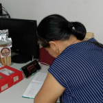 Loreta Gersava is surrounded by packaged food products and recording information.