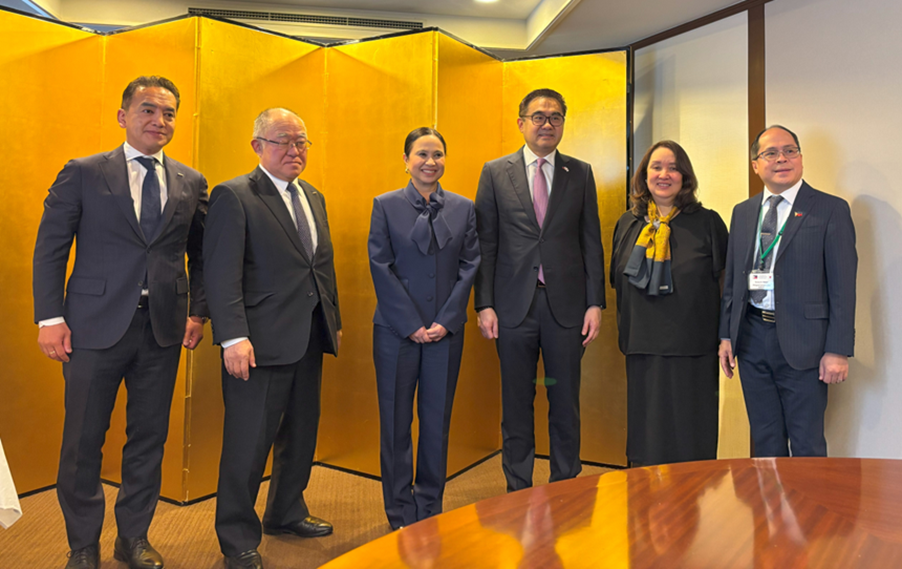 A group photograph features six individuals, including Secretary Cristina A. Roque (Department of Trade and Industry) and other officials from both the Philippines and Japan. They are posing in front of a traditional Asian gold folding screen. The group includes Mr. Koji Shimano, Mr. Tatsuya Nishimoto, SAPIEA Frederick D. Go, Special Trade Representative Dita Angara-Mathay, and Director General Tereso Panga. 