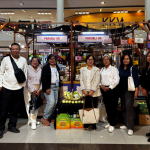 At KULTURA Fest 2025, DTI Region 6 Regional Director Rachel Nufable, wearing a brown blazer, and DTI staff visit the Panublion Western Visayas booth. The booth displays local products. The DTI staff poses in front of it. The booth is in a mall.