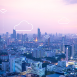 City skyline with cloud and WiFi connection symbols, representing technology and connectivity.