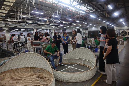 DTI Rizal and REMAI members touring Dedon Manufacturing, weavers crafting rattan furniture.